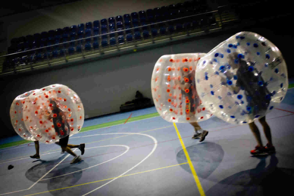 Players colliding in inflatable bumper balls