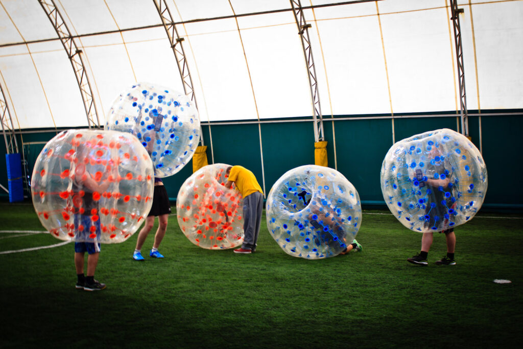 Bumper ball game on artificial turf in a dome hall
