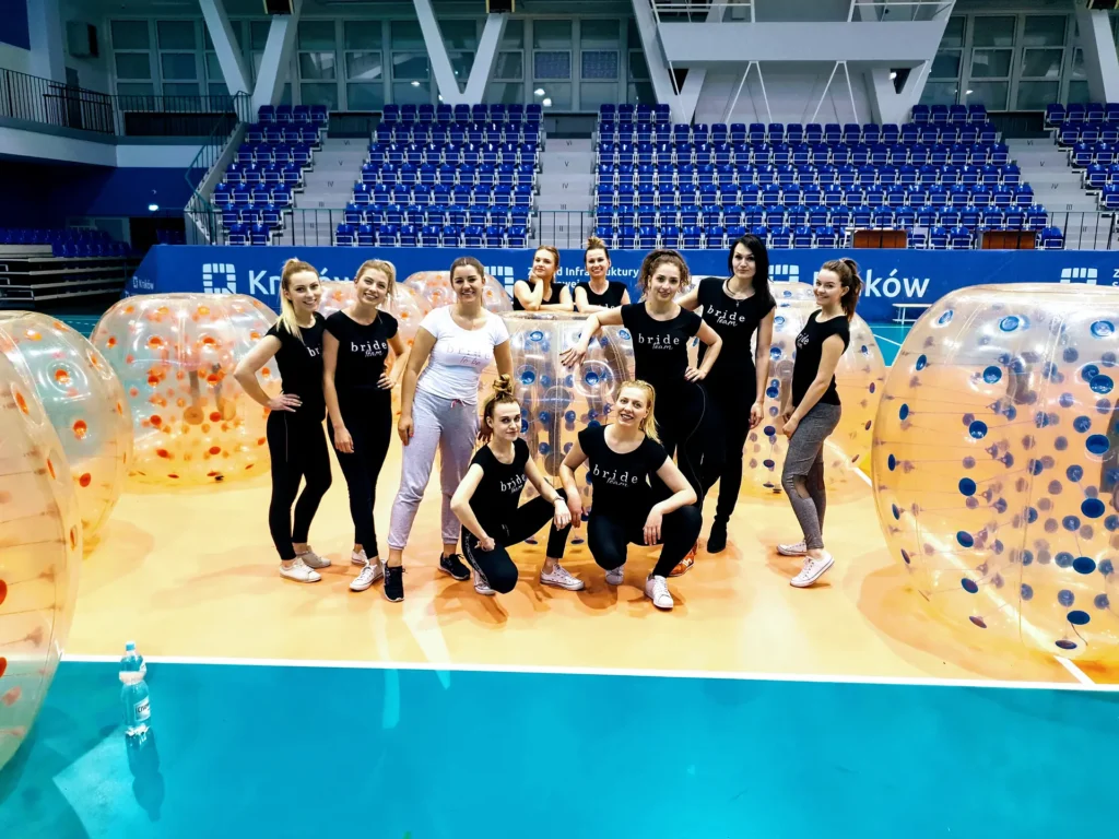 A group of women with bumper balls in a sports hall in Krakow