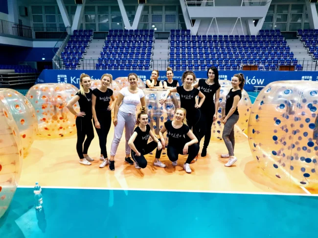 A group of women with bumper balls in a sports hall in Krakow