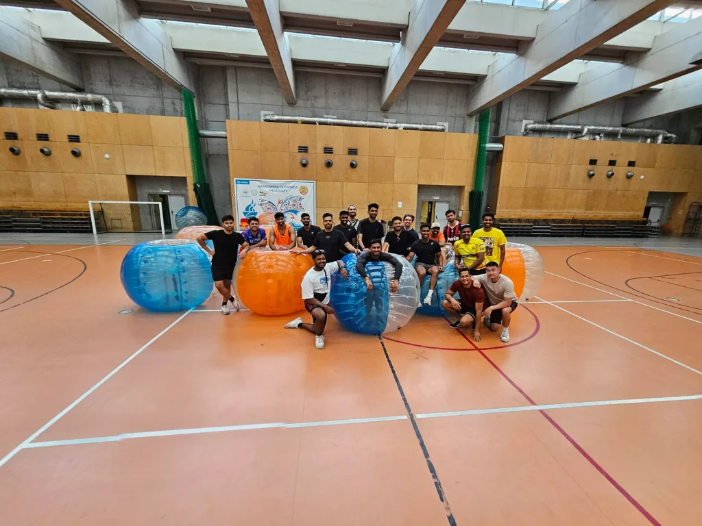 A group of men with bumper balls before a match in a sports hall